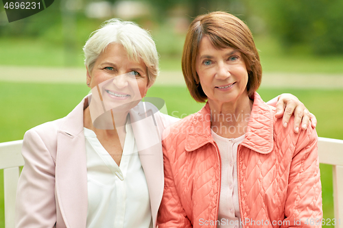 Image of senior women or friends sitting on bench at park