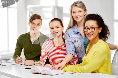 Image of high school students with books and notebooks