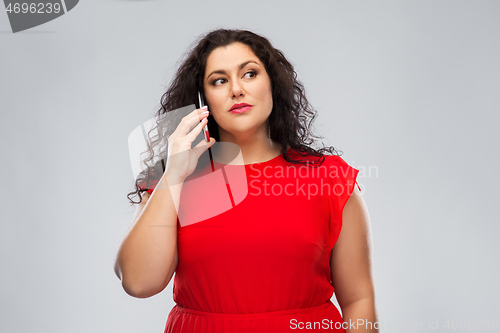 Image of woman in red dress calling on smartphone