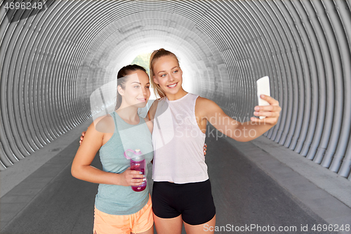 Image of sporty women taking selfie by smartphone outdoors