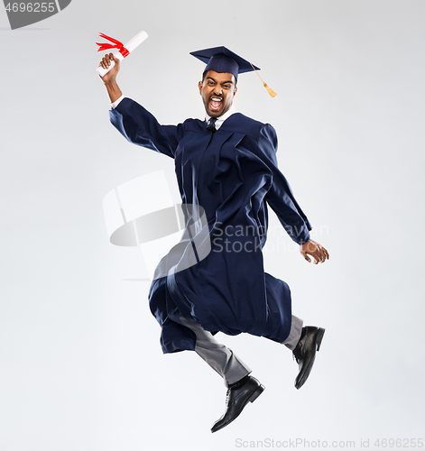 Image of happy jumping indian graduate student with diploma