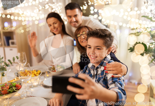 Image of family having dinner party and taking selfie