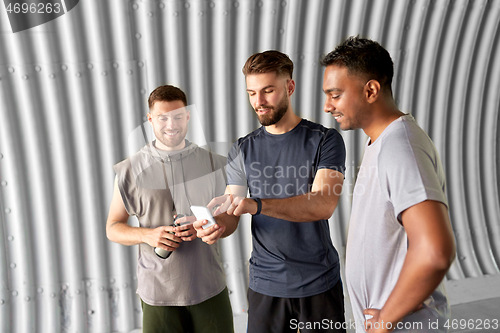Image of sporty men or friends with smartphone outdoors