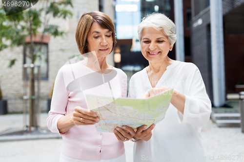 Image of senior women with city map on street in tallinn