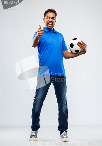 Image of football fan with soccer ball showing thumbs up