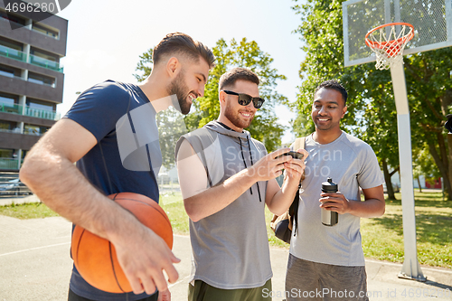 Image of men with smartphone on basketball playground