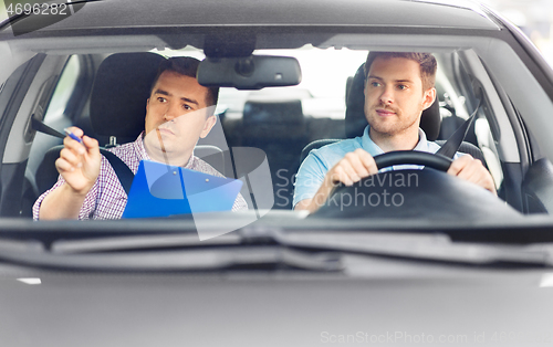 Image of car driving school instructor and young driver