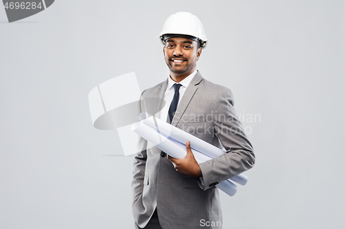 Image of indian male architect in helmet with blueprints