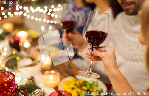 Image of close up of friends drinking red wine on christmas