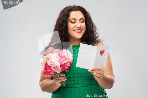 Image of happy woman with flower bunch and greeting card