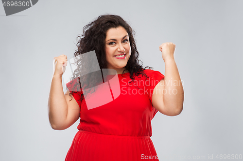 Image of happy woman in red dress celebrating success