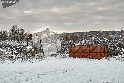 Image of Oil well on a winter landscape
