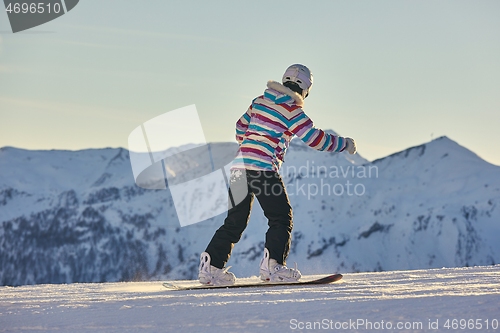 Image of Female snowboarder in the Alps