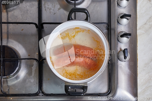 Image of Boiling sausages on stove