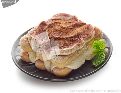 Image of Tiramisu dessert on black plate