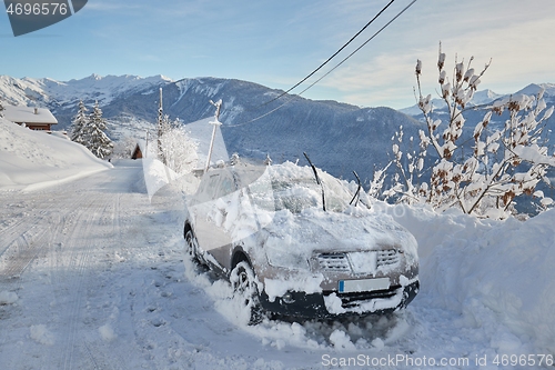 Image of Winter road and snowy car