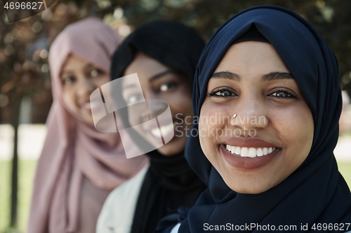 Image of businesswoman group portrait wearing traditional islamic clothes