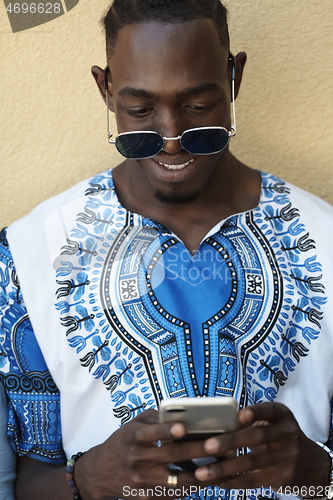 Image of native african black man using smart phone