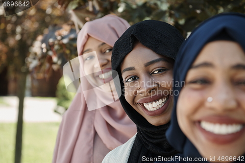 Image of businesswoman group portrait wearing traditional islamic clothes