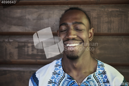 Image of portrait of a smiling young african man wearing traditioinal clothes