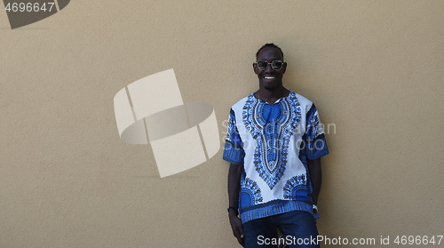 Image of portrait of a smiling young african man wearing traditioinal clothes