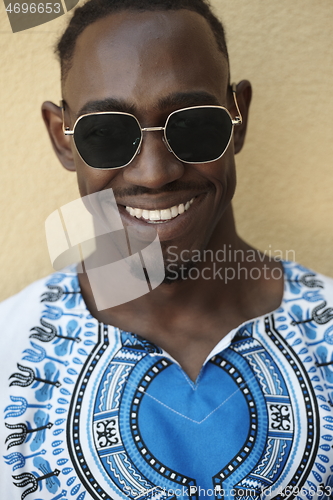 Image of portrait of a smiling young african man wearing traditioinal clothes