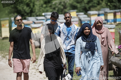 Image of people group visiting local honey production farm