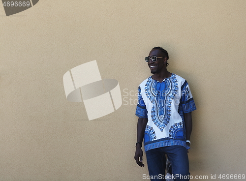 Image of portrait of a smiling young african man wearing traditioinal clothes