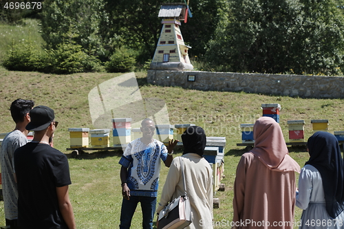 Image of people group visiting local honey production farm