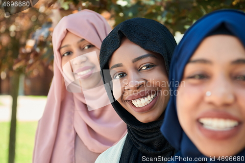 Image of businesswoman group portrait wearing traditional islamic clothes