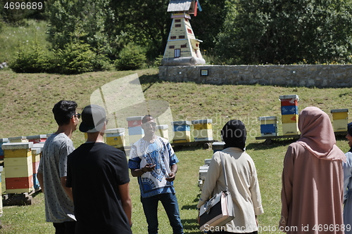 Image of people group visiting local honey production farm