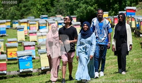 Image of people group visiting local honey production farm