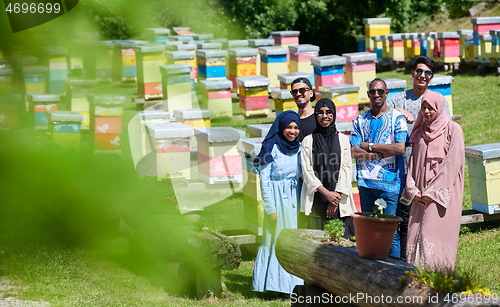 Image of people group visiting local honey production farm