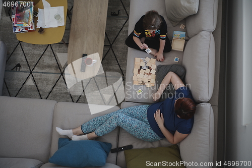 Image of mother and daughter at home playing memory game