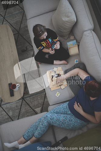 Image of mother and daughter at home playing memory game