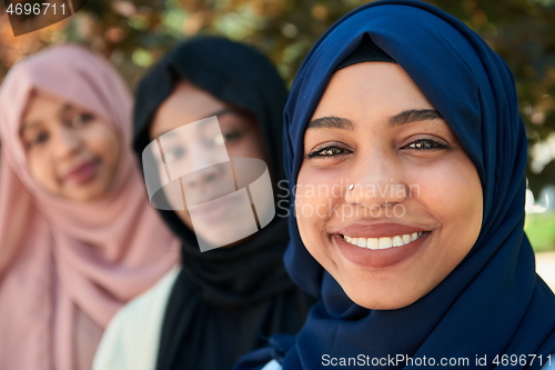 Image of businesswoman group portrait wearing traditional islamic clothes