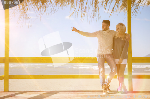 Image of Couple chating and having fun at beach bar