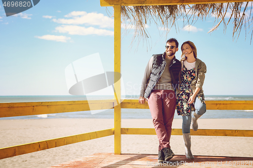 Image of Couple chating and having fun at beach bar