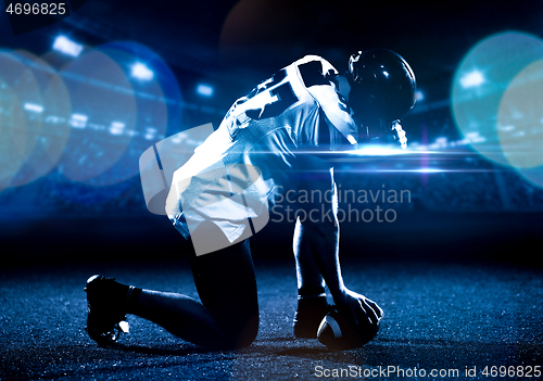 Image of American football player starting football game