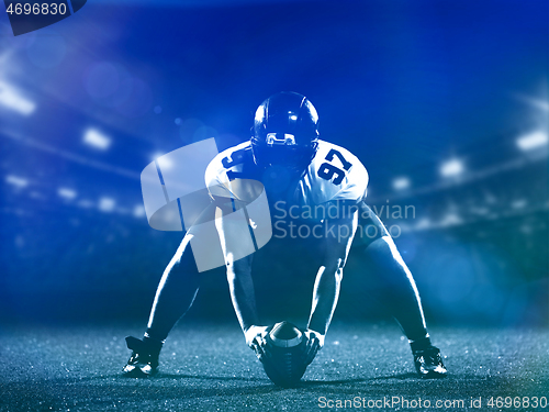 Image of American football player starting football game