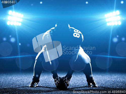 Image of American football player starting football game