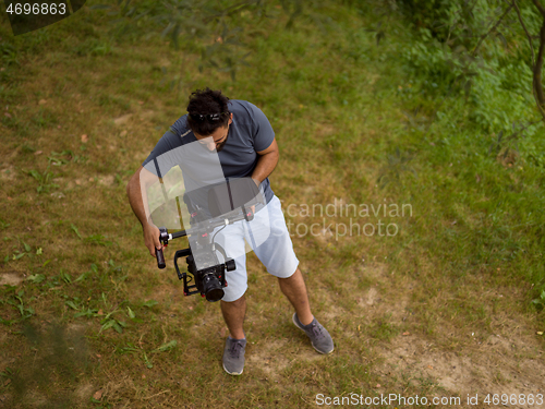 Image of videographer at work in beautiful nature