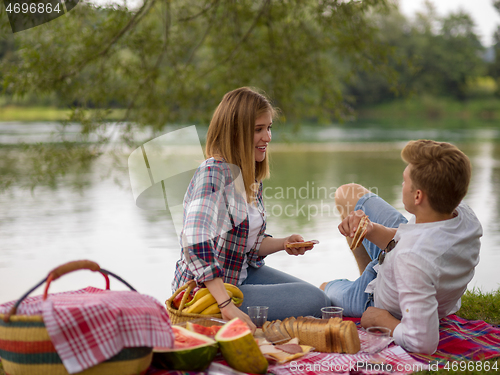 Image of Couple in love enjoying picnic time