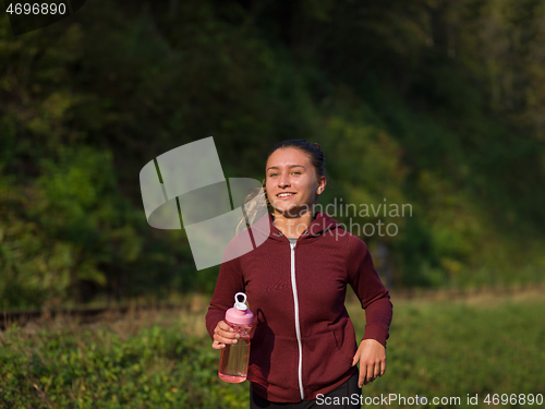 Image of woman jogging along a country road