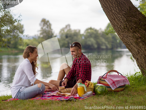 Image of Couple in love enjoying picnic time