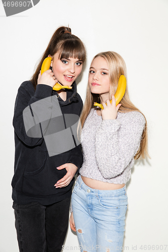 Image of Close up fashion portrait of two young pretty hipster teens