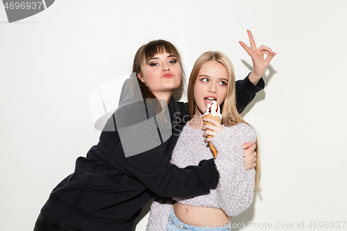 Image of Close up fashion portrait of two young pretty hipster teens