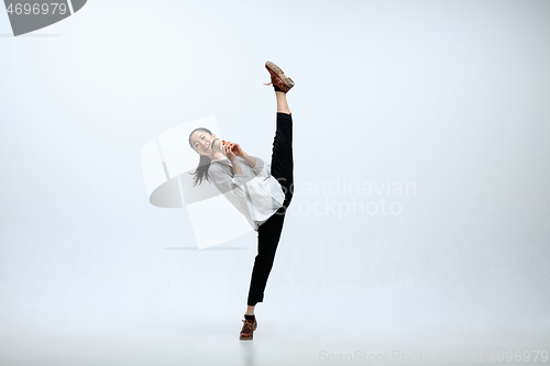 Image of Woman working at office and jumping isolated on studio background