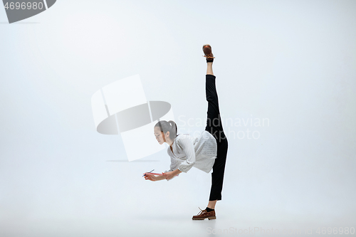 Image of Woman working at office and jumping isolated on studio background