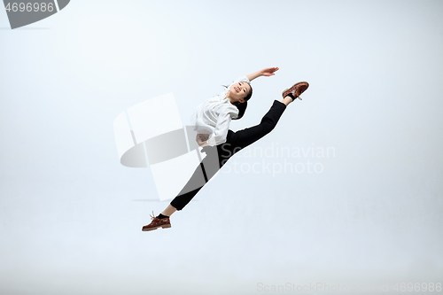 Image of Woman working at office and jumping isolated on studio background